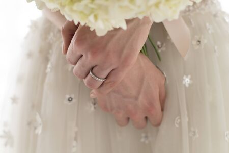 Close-up of the hands of the bride wearing a wedding ringの写真素材