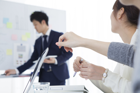 Business women are focused on the whiteboardの写真素材