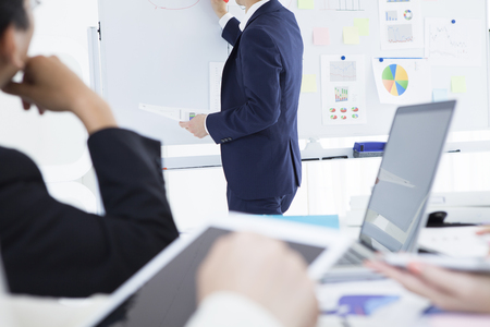 Businessman have an announcement using the whiteboardの写真素材