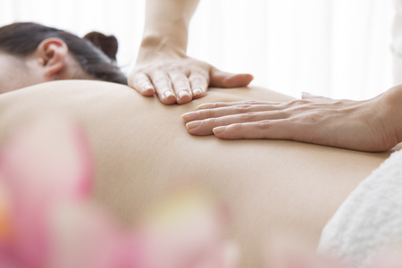 Esthetician to massage the back of the customerの写真素材