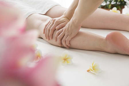 Woman to be a strong massage the calf at the storeの写真素材