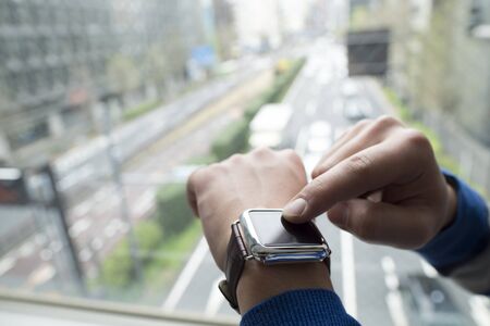 Touch the smart watch using my hand.の写真素材