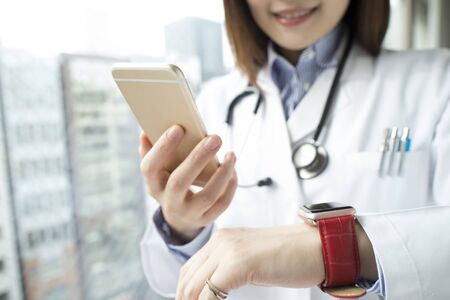 White coat and a smart phone and a smart watch and Venusの写真素材