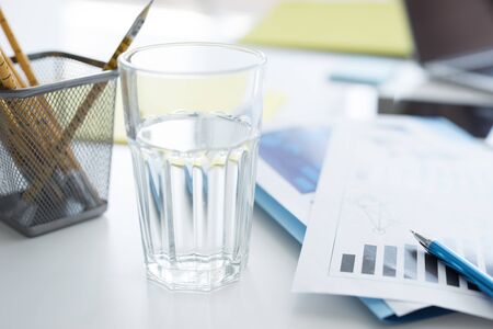 A glass of water on the deskの写真素材