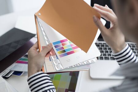 Designer looking at color chart