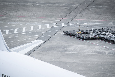 Pictures of airplanes and cargo loaders at the airport.の写真素材