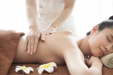 Beautiful woman receiving massage with beauty treatment.の写真素材