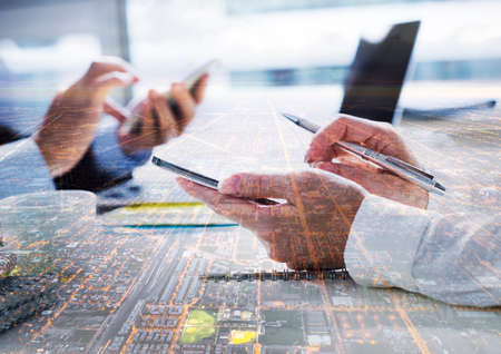 Two business people. Dual exposure of people and cities. Consulting on business projects, successful negotiations.の写真素材