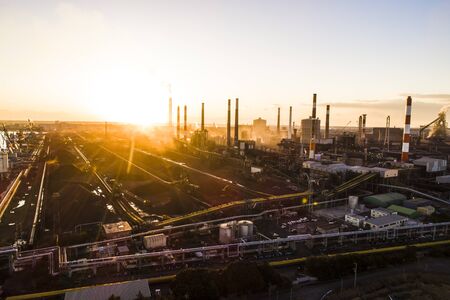 Aerial photograph of the setting sun and large energy facility.の写真素材