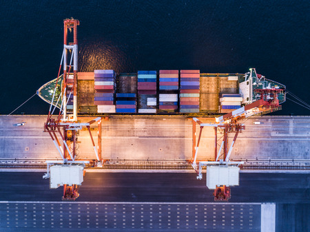 Aerial shooting of a large container ship at night. Viewpoint from directly above.の写真素材