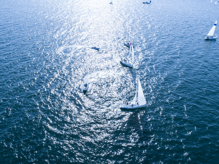 Sea that reflects yachts and sunshine. Shadow of sails.の写真素材