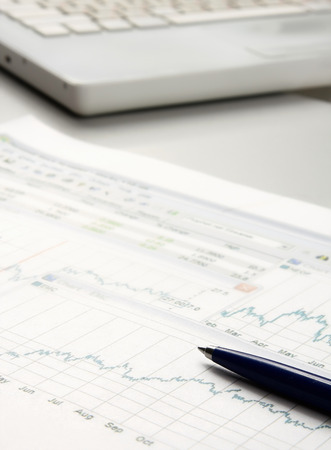 Laptop, pen, document on the deskの写真素材