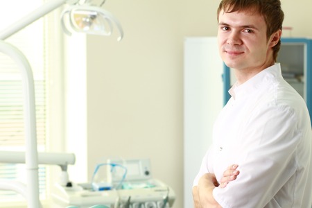 Man dentist at his office smilingの写真素材