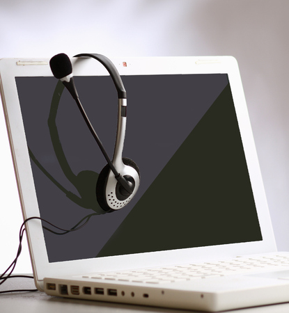 Headset with Laptop on  desk.の写真素材