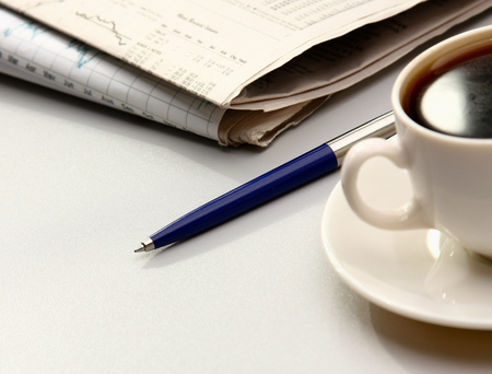 cup near newspapers.の写真素材