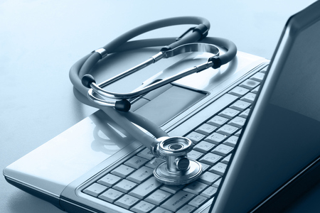 Stethoscope resting on a computer keyboard.