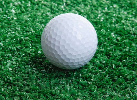 Golf ball ower green grassの写真素材