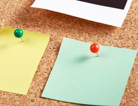 Cork message board with various paper notesの写真素材