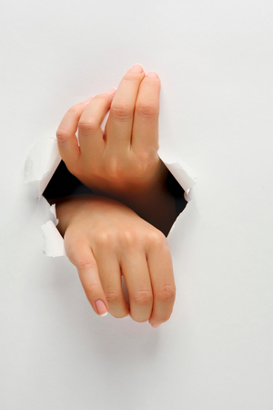 Female hands opening a holeの写真素材