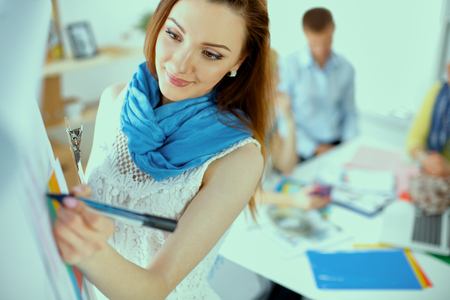 Young woman drawing on wihteboard with white copyspaceの写真素材
