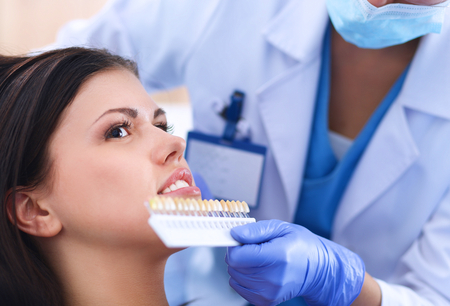 Woman dentist working at her patients teeth .の写真素材
