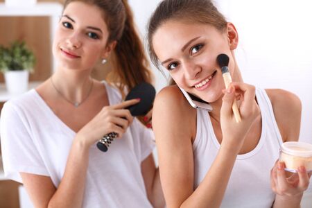 Two young women pampering themselves at a sleepover.の写真素材
