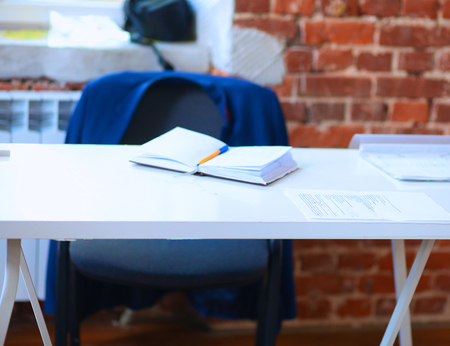 Laptop  computer on the desk ,businesspeople standing in the background.の写真素材