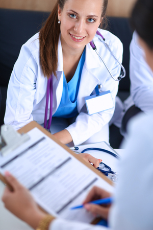 Happy medical team discussing and working together .の写真素材