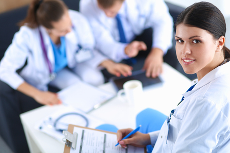 Happy medical team discussing and working together .の写真素材