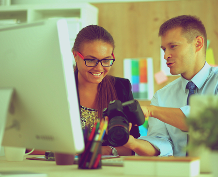 Fashion designers working in studio sitting on the desk .の写真素材