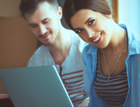 Young couple  sitting on the floor of their new apartment.の写真素材