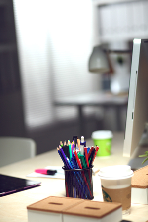Designer desk with laptop in the office .の写真素材