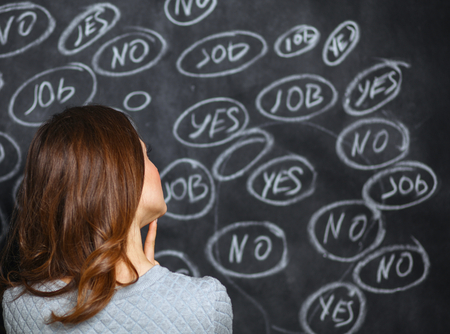 Thinking young woman with yes or no choice on grey background