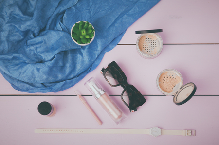 Sunglasses, cosmetics makeup and essentials on wooden backgroundの写真素材