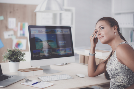Fashion designers working in studio sitting on the deskの写真素材