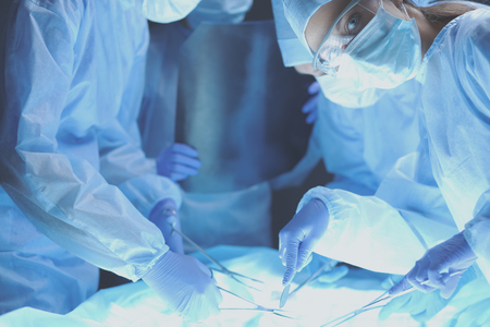 Team surgeon at work on operating in hospitalの写真素材