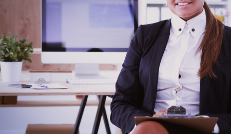 Young woman working in office, sitting at desk.の写真素材