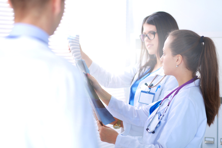 Young group of doctors looking at x-rayの写真素材