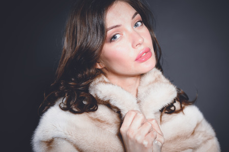 Portrait of a beautiful woman in jacket with fur.
