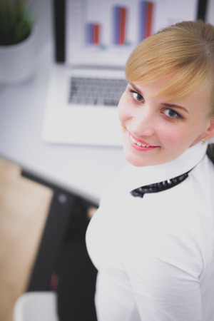 Portrait of businesswoman sitting at deskの写真素材