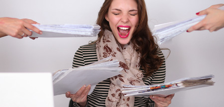 Portrait of tired young business woman with laptop computerの写真素材