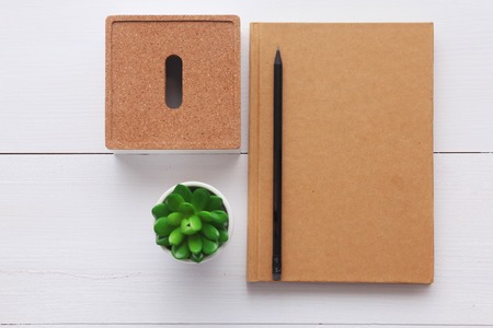 Top view image of open notebook with blank pages on wooden table