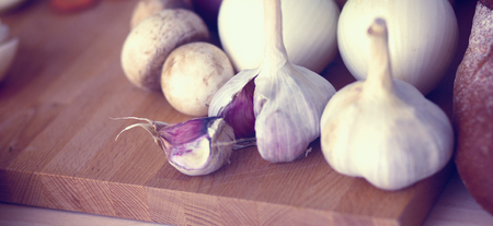 Young woman cutting vegetables in the kitchenの写真素材