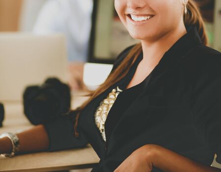 Young woman working in office, sitting at desk.の写真素材