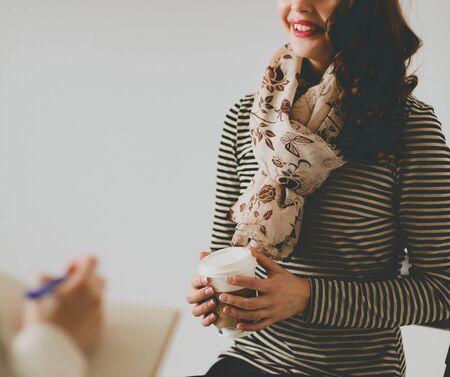 Portrait of happy brunette with mug in hands .