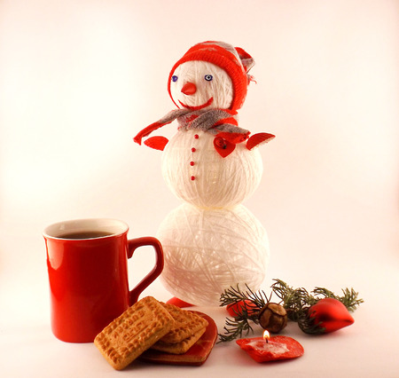 Tea with Christmas cookies and knitted snowmanの写真素材
