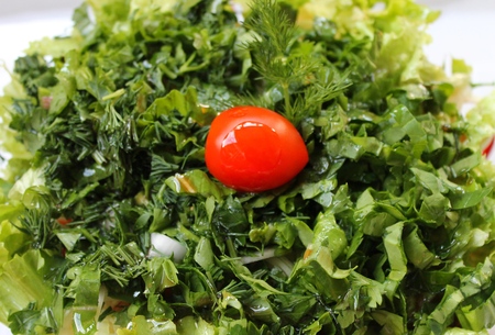 Salad of vegetables and greens with grains on a plateの写真素材