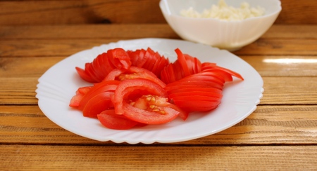 Fresh tomato sliced ??on a white plateの写真素材