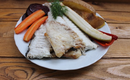 Fish dorado baked in the oven with vegetable garnish