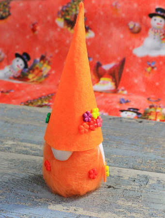 Christmas Scandinavian Gnome from Felt Handmade Handmade sewing of a Christmas Scandinavian gnome with a beard in a long capの写真素材